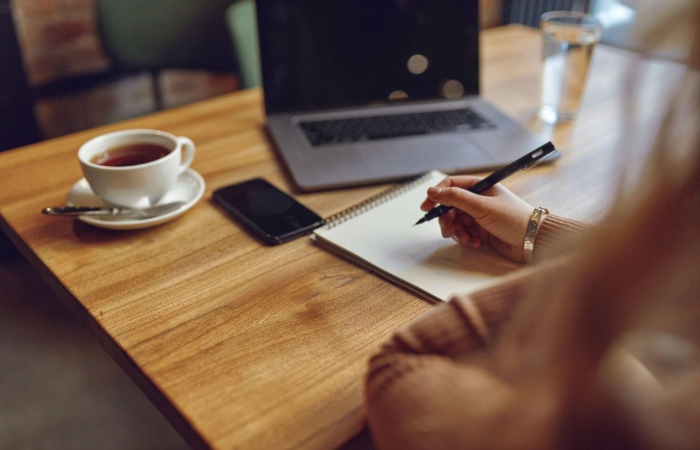 https://www.istockphoto.com/photo/woman-using-laptop-and-smartphone-for-remote-work-gm1327846362-412087912?phrase=woman%2Bwriting